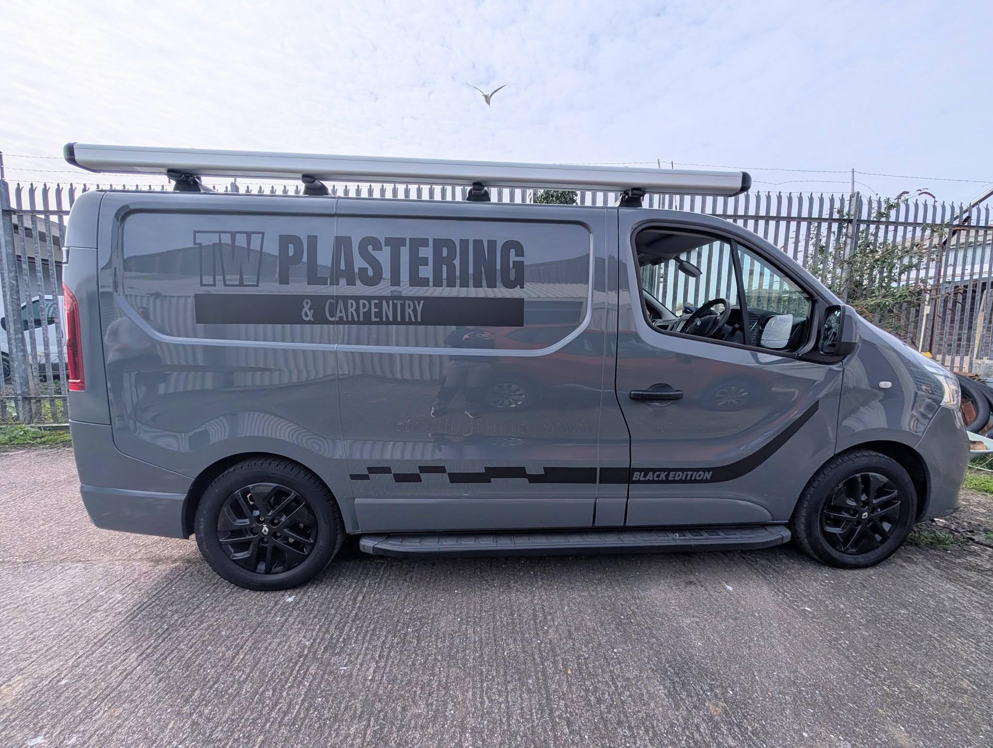 TW Plastering dark vinyl van wrap